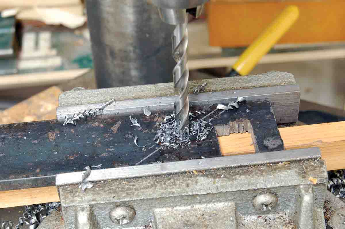 Drilling the barrel band hole using a drill press and common twist drills.